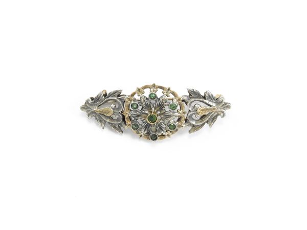 Yellow gold and silver brooch with emeralds