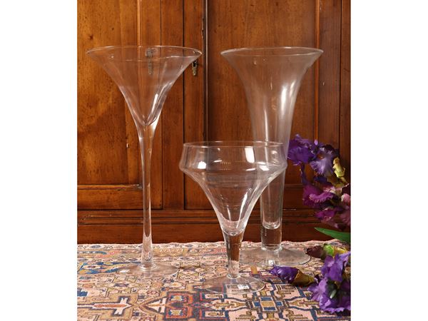 Three transparent glass vases for compositions