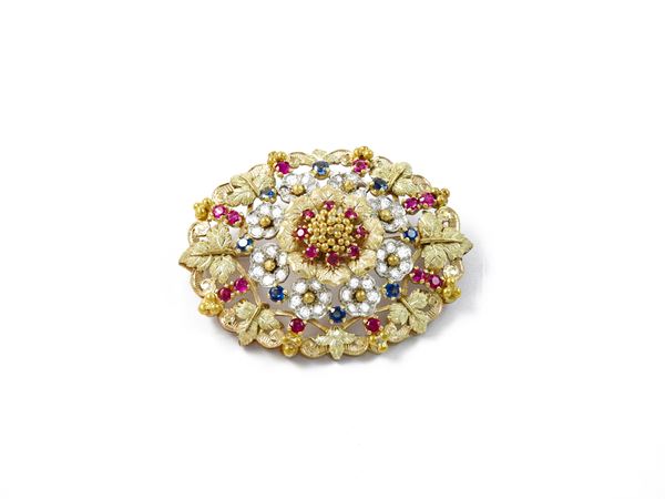White and yellow gold brooch with diamonds, rubies and sapphires