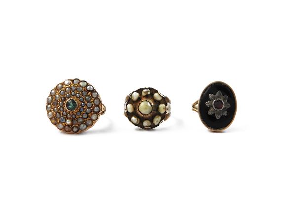 Three low title gold and silver rings with pearls and colored glass paste