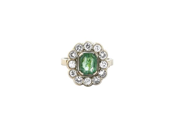 White gold ring with diamonds and emerald