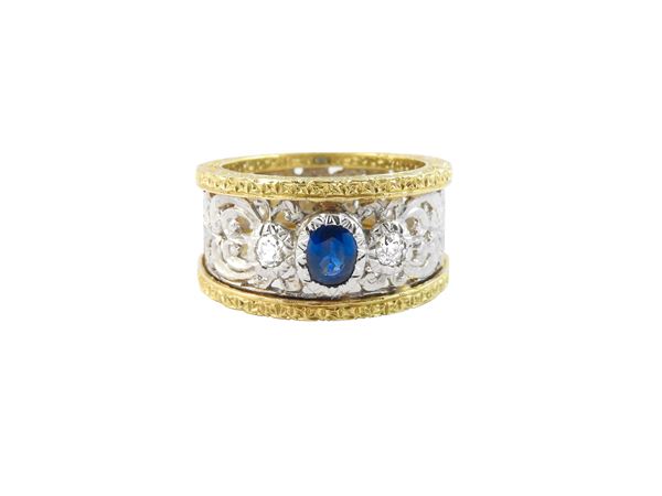 White and yellow gold band ring with diamonds and sapphire