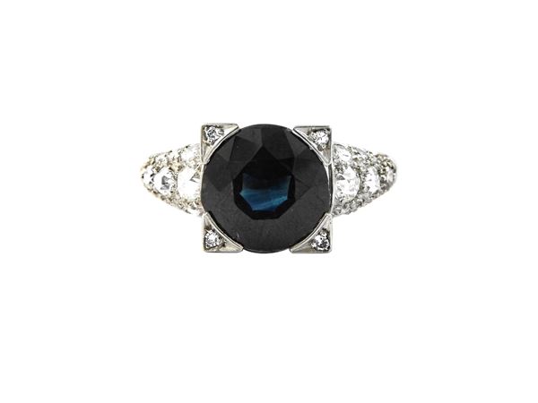 Platinum ring with diamonds and sapphire