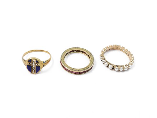 Three low title gold rings with blue enamel diamonds, synthetic rubies and pearls
