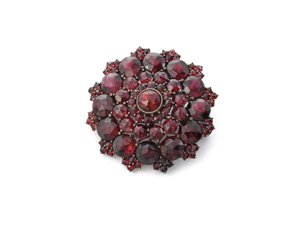 Gilded silver brooch with garnets