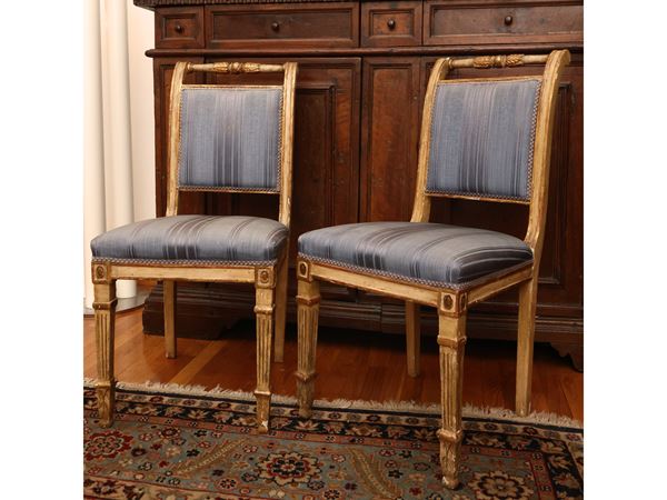Series of four chairs in ivory lacquered wood highlighted in gold