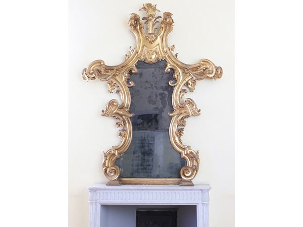Large fireplace with carved and gilded wooden frame
