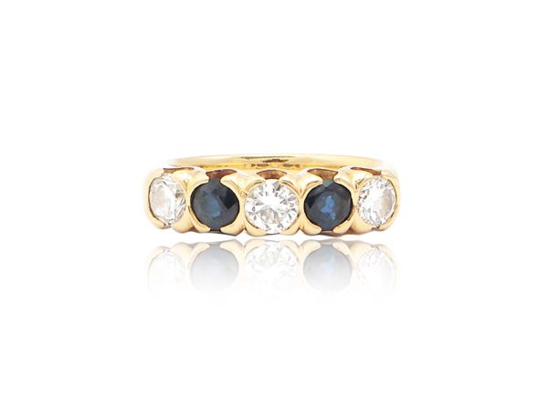 Riviere ring in yellow gold with diamonds and sapphires