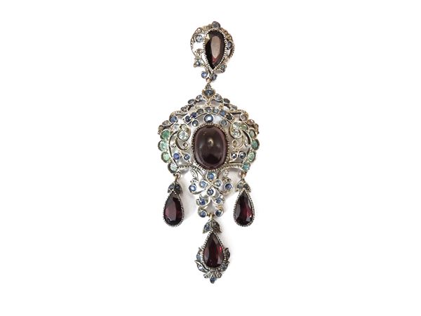 Low title gold and silver pendant with sapphires, emeralds and garnets