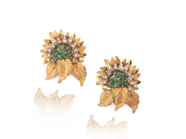 Pair of yellow and white gold brooches with diamonds and emeralds
