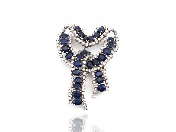 Brooch in platinum and white gold with diamonds and sapphires