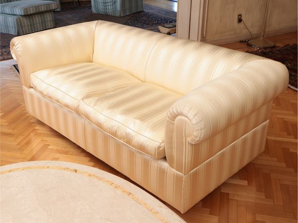 Shell sofa upholstered and covered in satin