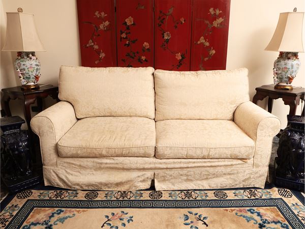 Upholstered sofa covered in damask
