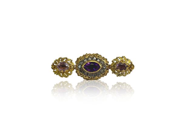 Brooch in yellow gold and silver with diamonds and amethysts