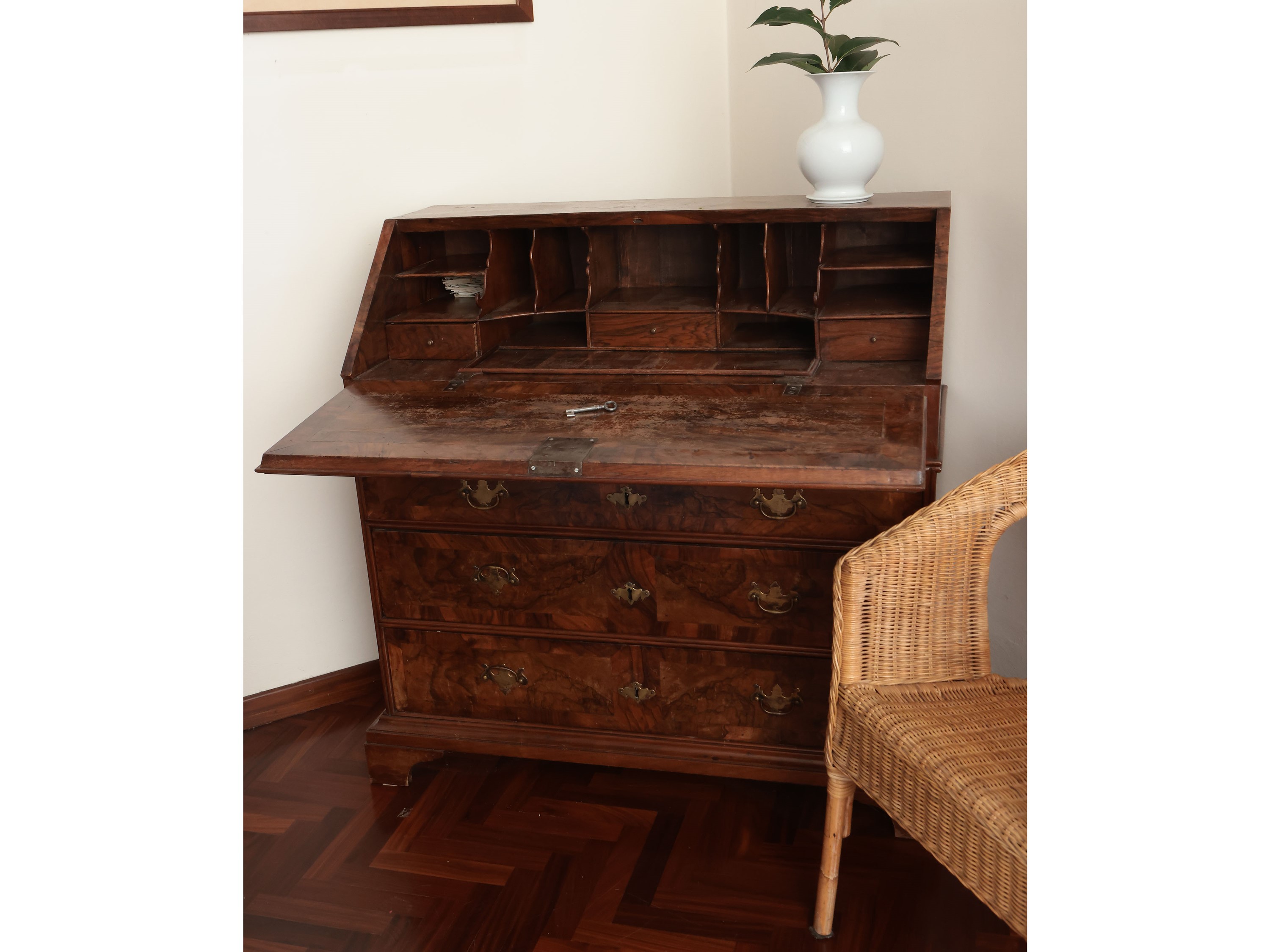 Cassettone a ribalta impiallacciato ed intarsiato in radica di noce