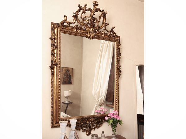 Grande specchiera con cornice in legno intagliato e dorato