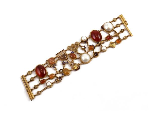 Bracelet in golden metal with enamels, pearls and various stones signed Percossi