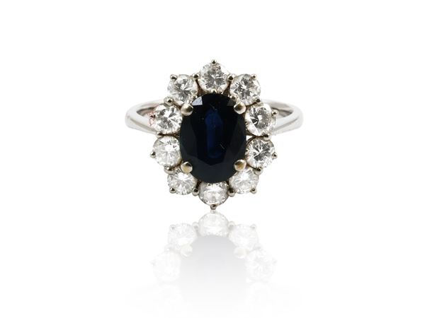 White gold ring with sapphire and diamonds