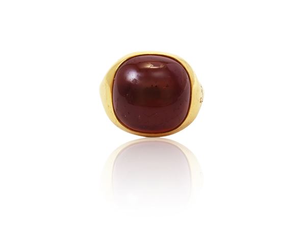 Yellow gold ring with cabochon garnet signed Pomellato collection Ori Barbari
