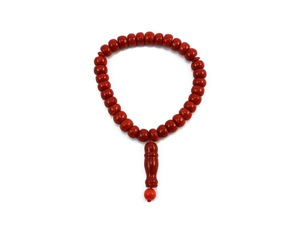 Rosary type elastic bracelet with coral paste