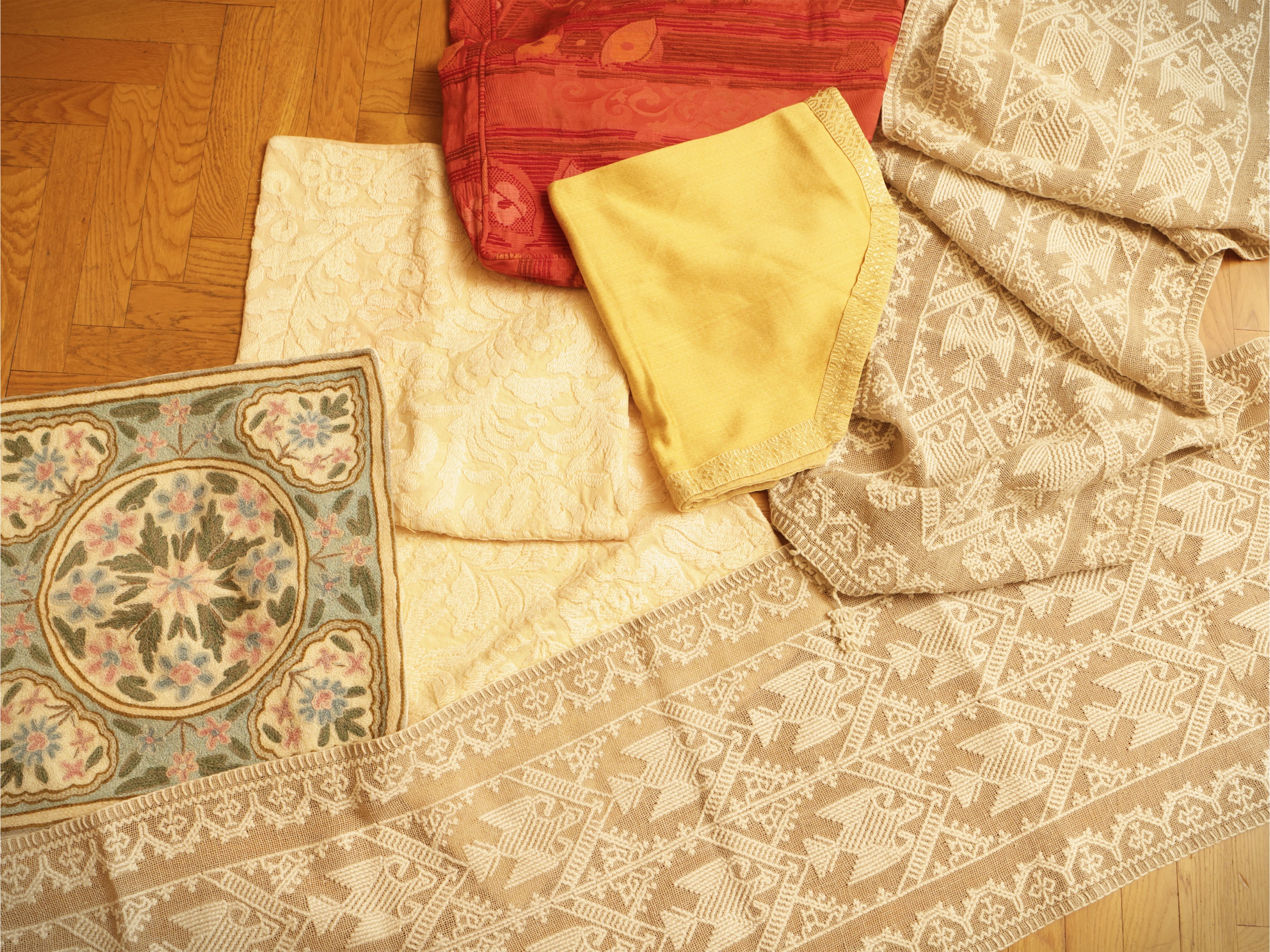 Assortimento di tessuti e tendaggi per la casa, inclusi seta damascata rossa e copricuscini