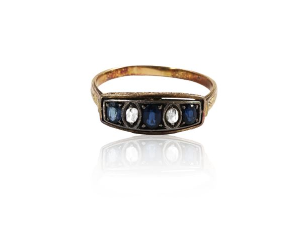 Yellow gold and silver riviere ring with diamonds and sapphires