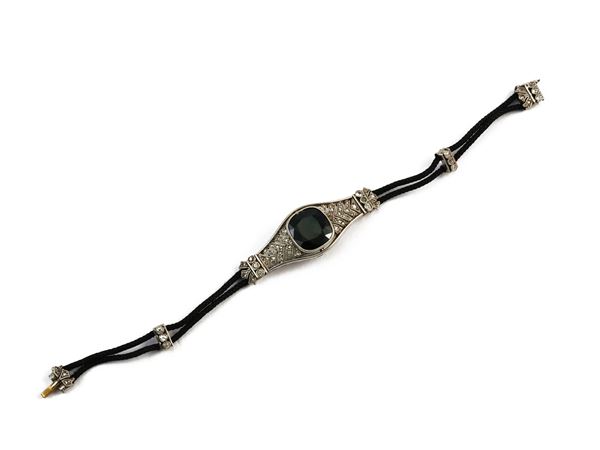 Cord bracelet with central platinum sapphire and diamonds element