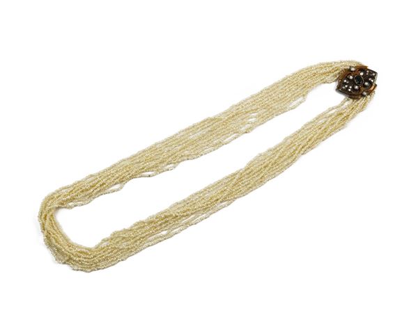 Multistrands of micropearls  with yellow gold, silver and diamonds clasp