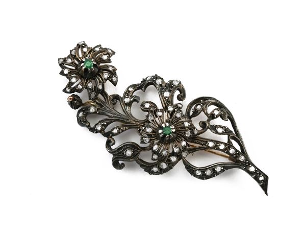 Silver and low title yellow gold floral brooch with diamonds and emeralds