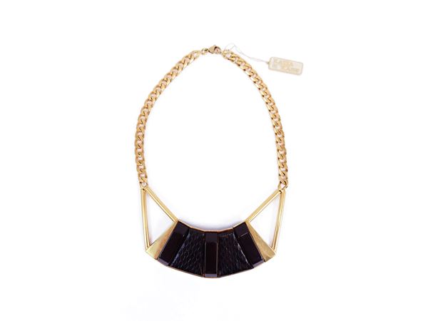 Golden Tone metal necklace with large central black python and resin shield
