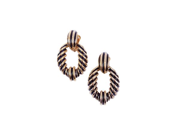 Clip-on earrings in golden tone metal and black enamel