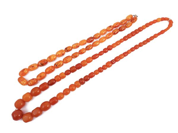 Two long resin necklaces in imitation of amber