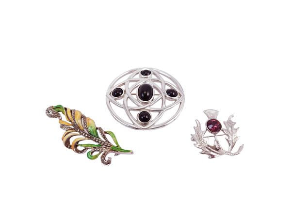 Three silver tone metal brooches