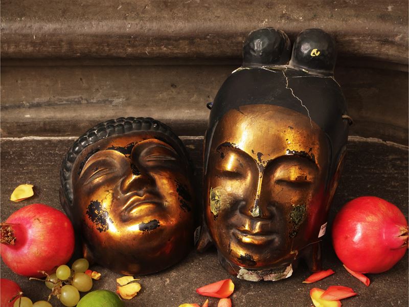 Due maschere orientali, raffiguranti teste di Buddha