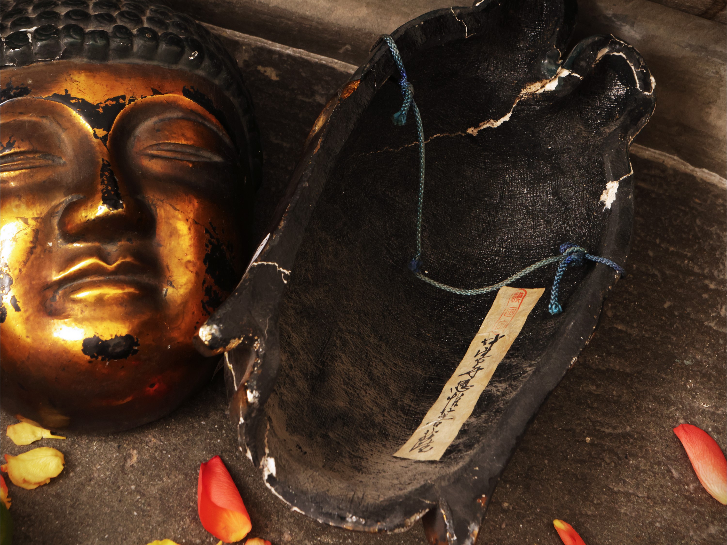 Due maschere orientali, raffiguranti teste di Buddha