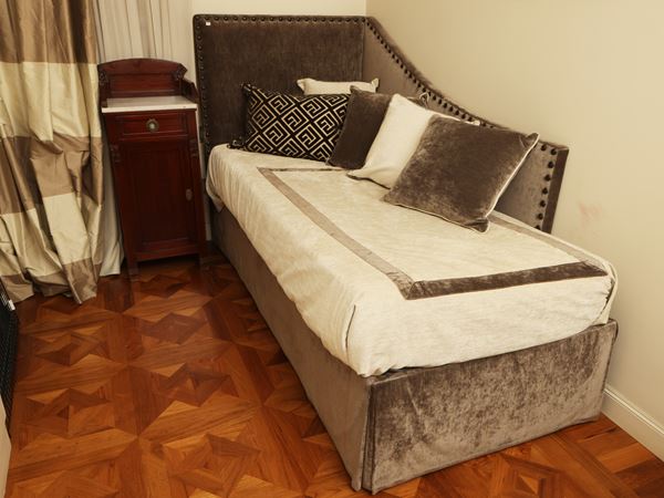 Single bed padded and covered in dove gray velvet