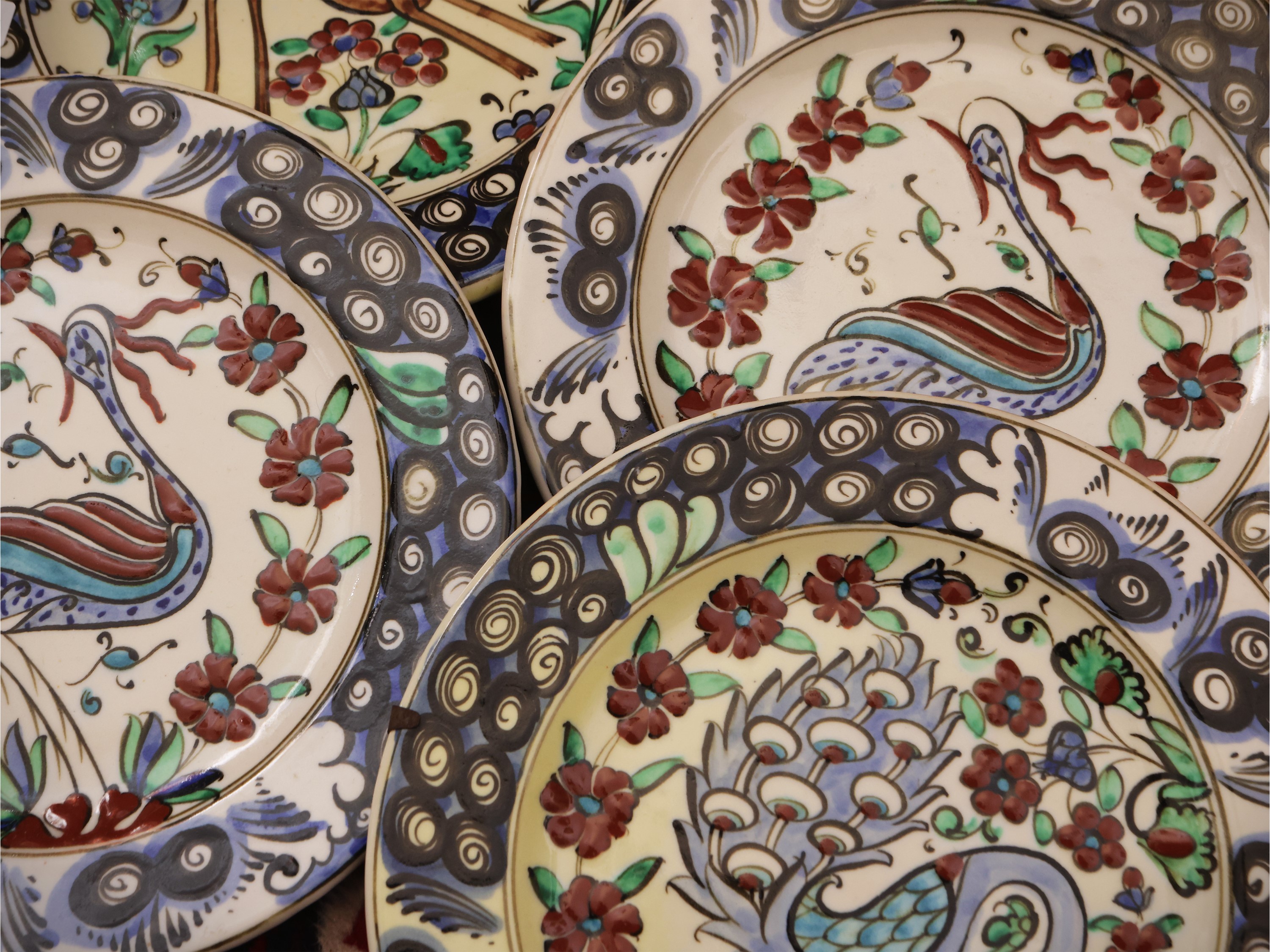 Serie di sei piatti in ceramica, decorazione animalier e tralci floreali
