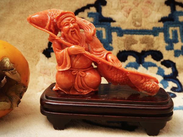 A coral figure of a fisherman with carp, China, late Qing dynasty