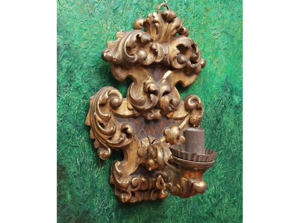 Large sconce in carved and gilded wood