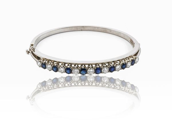 White gold bangle bracelet with diamonds and sapphires