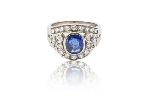 White gold ring with diamonds and sapphire