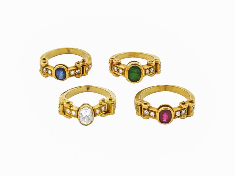Serie di quattro anelli in oro giallo con diamanti, rubino, zaffiro, smeraldo e zirconia cubica