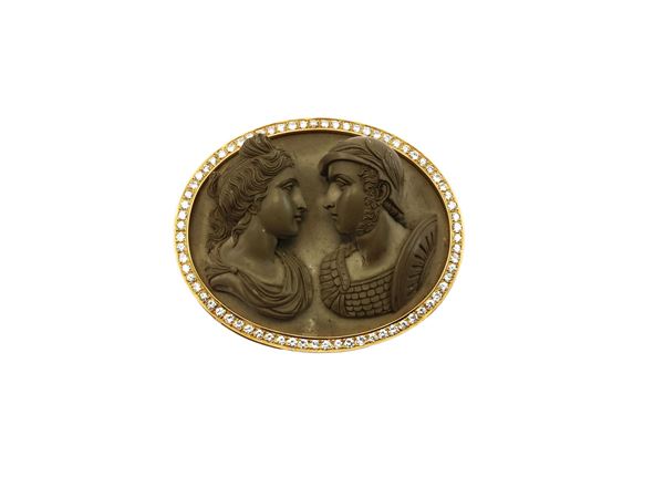 A yellow gold and diamonds oval pendant with lava stone cameo