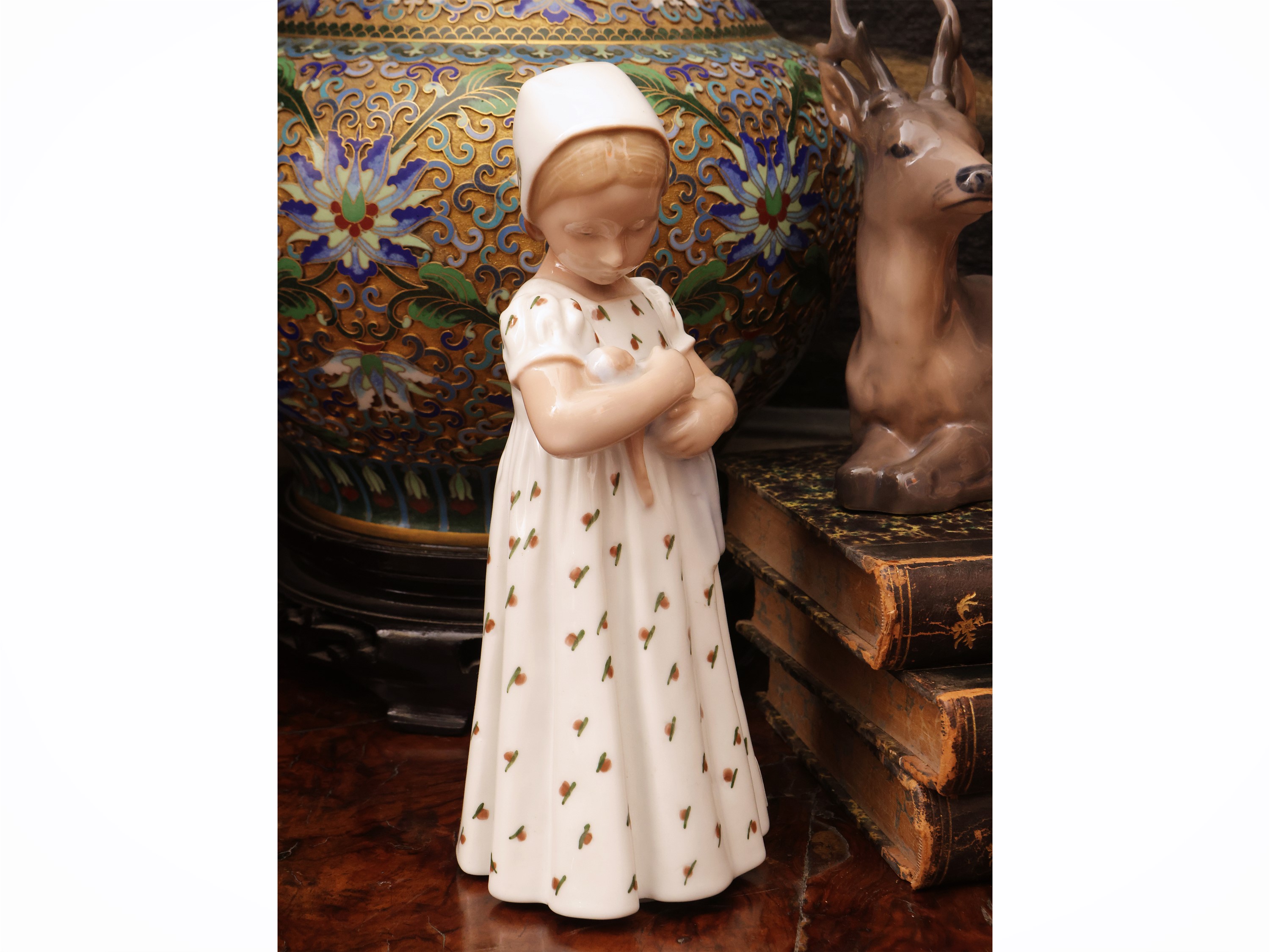 Royal Copenaghen, Cervo accucciato; B&G, Bambina con bambola; Porcellana, tre soprammobili da col...