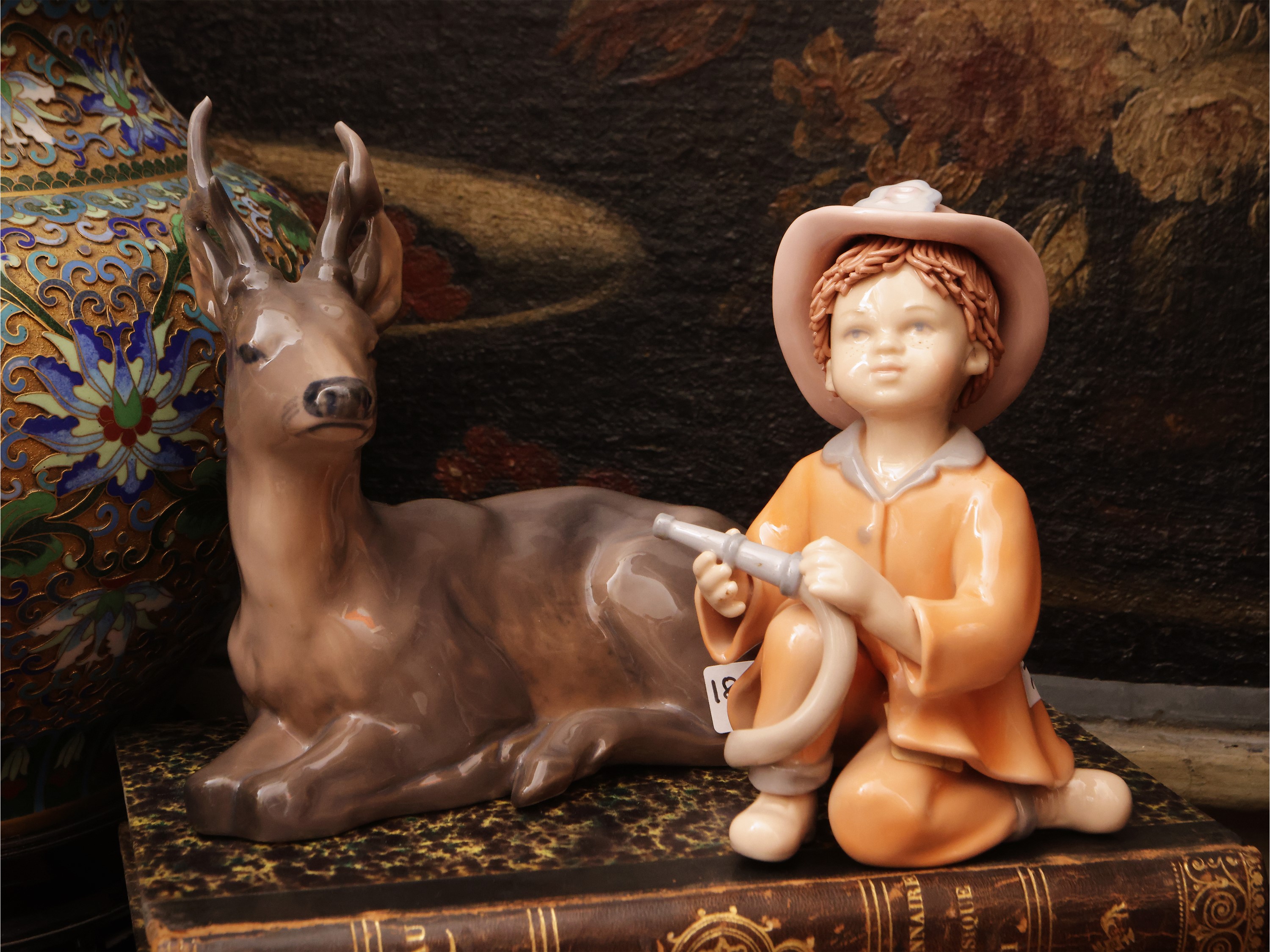 Royal Copenaghen, Cervo accucciato; B&G, Bambina con bambola; Porcellana, tre soprammobili da col...