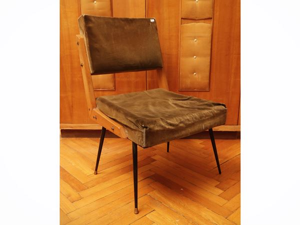 Chair upholstered in olive green velvet