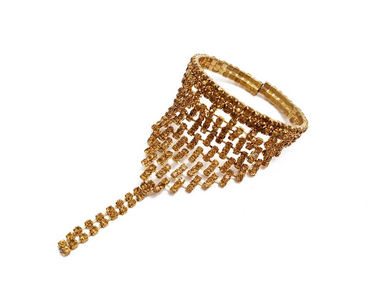 Bracciale semirigido in metallo dorato con strass color topazio