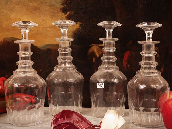 Series of four cut crystal wine bottles