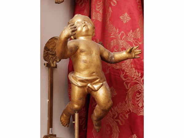 Carved and gilded wooden putto