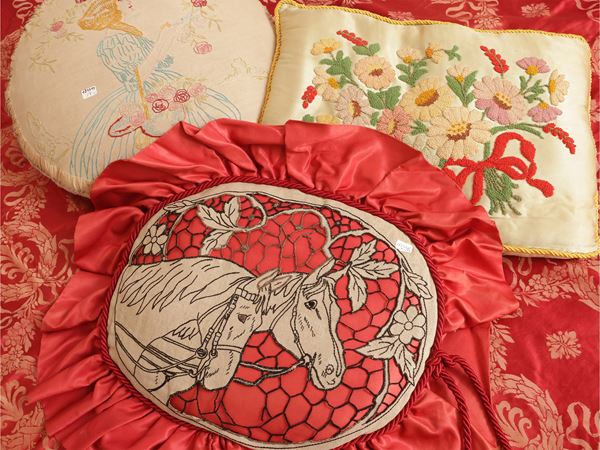 Three embroidered cushions